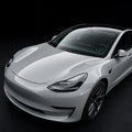 Super Gloss Volcano Gray PET vinyl wrap film on a car, front three-quarter studio view