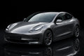 Super Gloss Metallic Graphite Gray PET vinyl wrap film on a car, front three-quarter studio view