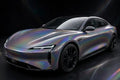 Super Gloss 3D Iridescent Psychedelic Gray PET vinyl wrap film on a car, front three-quarter studio view