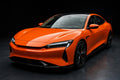 Super Gloss Hermes Orange PET vinyl wrap film on a car, front three-quarter studio view
