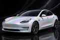 Super Gloss Iridescent Psychedelic White PET vinyl wrap film on a car, front three-quarter studio view