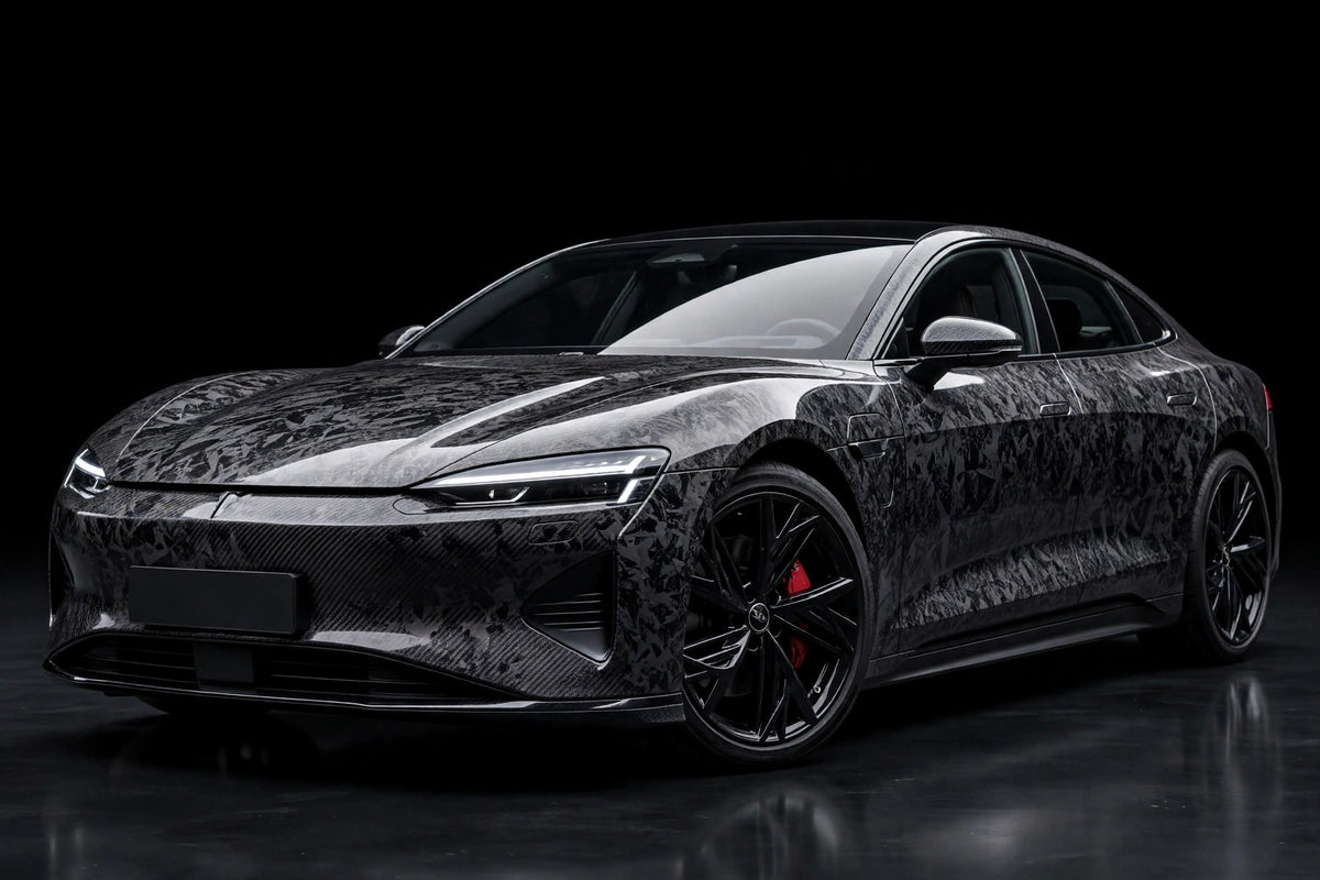 Black Forged Carbon Fiber PET vinyl wrap film on a car, front three-quarter studio view