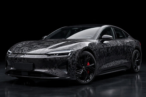 Black Forged Carbon Fiber PET vinyl wrap film on a car, front three-quarter studio view