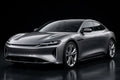 Super Gloss Titanium Steel Gray Metallic PET vinyl wrap film on a car, front three-quarter studio view