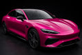 Super Gloss Magenta Pink PET vinyl wrap film on a car, front three-quarter studio view