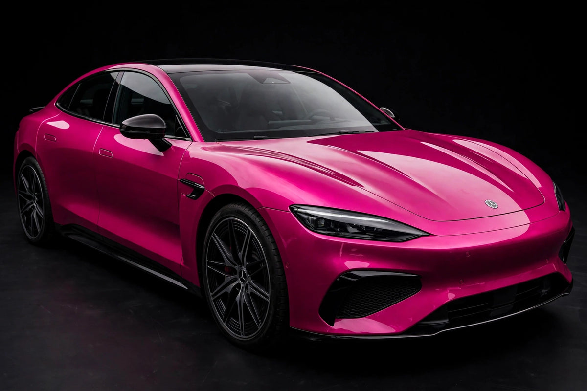 Super Gloss Magenta Pink PET vinyl wrap film on a car, front three-quarter studio view