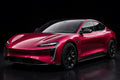 Super Gloss Rubrllite Red Metallic PET vinyl wrap film on a car, front three-quarter studio view