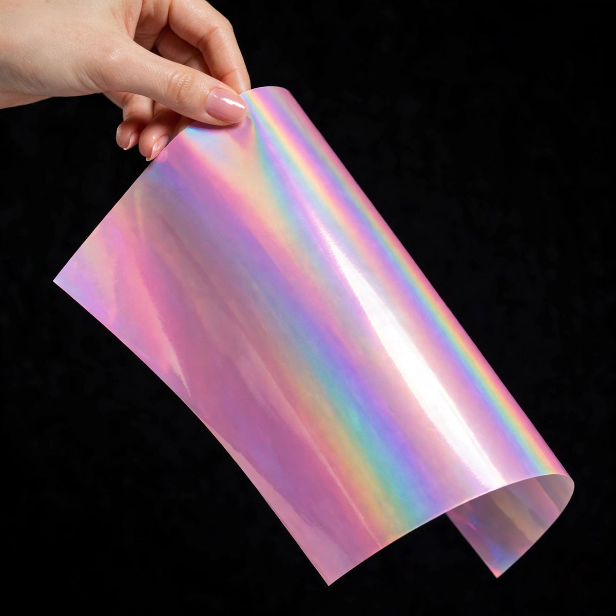 Super Gloss Iridescent Psychedelic Pink vinyl wrap film sheet held in hand
