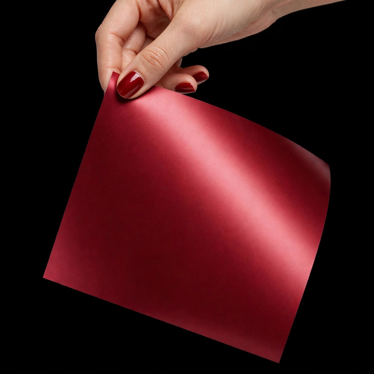 Ultra Matte Chrome Romani Red vinyl wrap film sheet held in hand