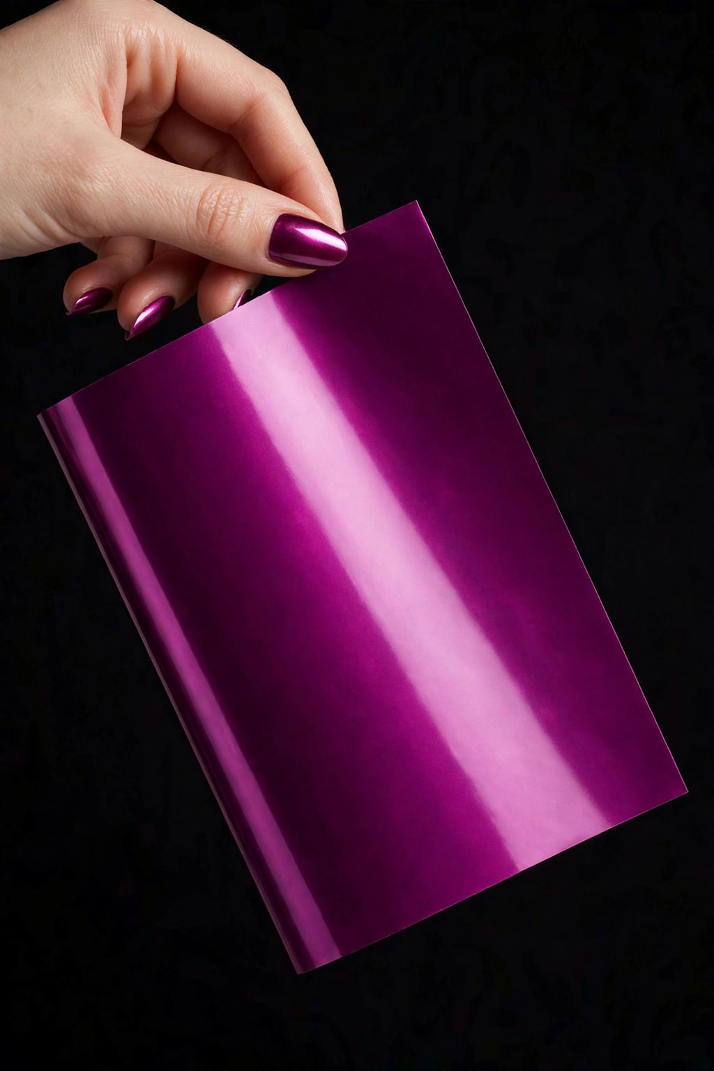 Super Gloss Widdberry Juice Metallic vinyl wrap film sheet held in hand