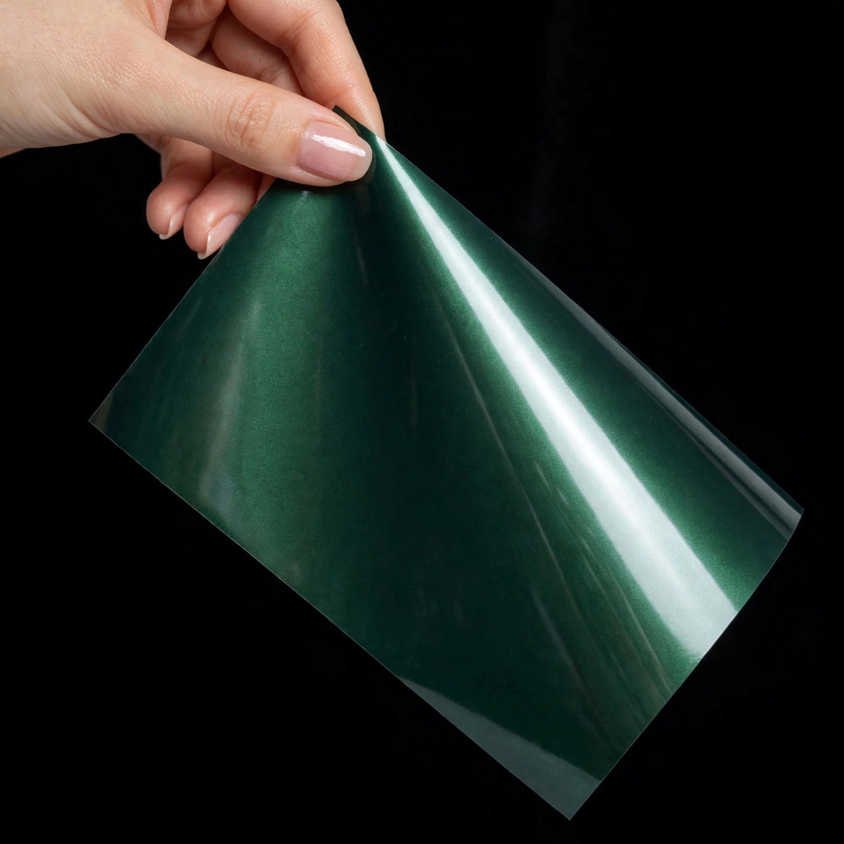 Super Gloss Metallic Dark Jade Green vinyl wrap film sheet held in hand