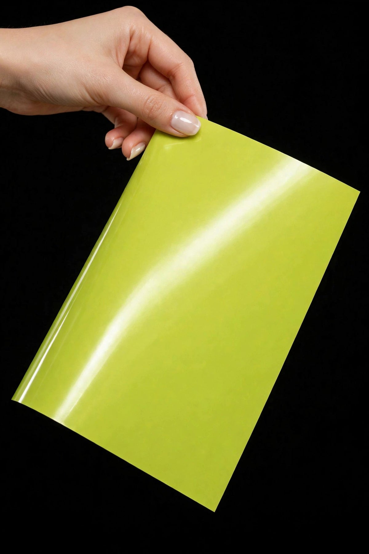 Super Gloss Coral Yellow vinyl wrap film sheet held in hand