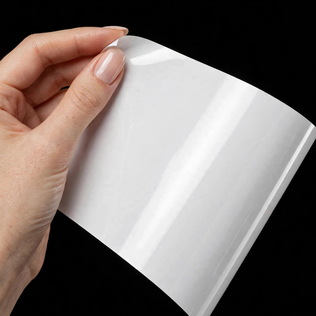 Super Gloss Pure White vinyl wrap film sheet held in hand