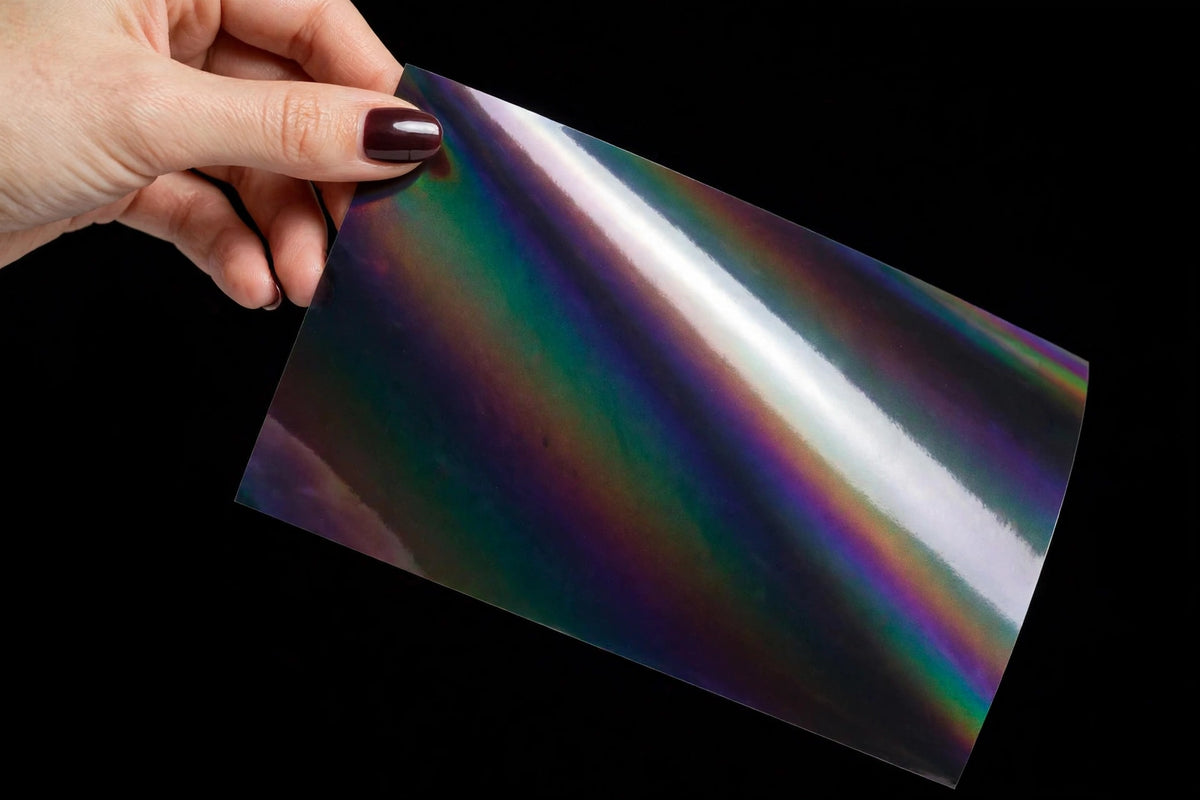 Super Gloss Iridescent Psychedelic Black vinyl wrap film sheet held in hand