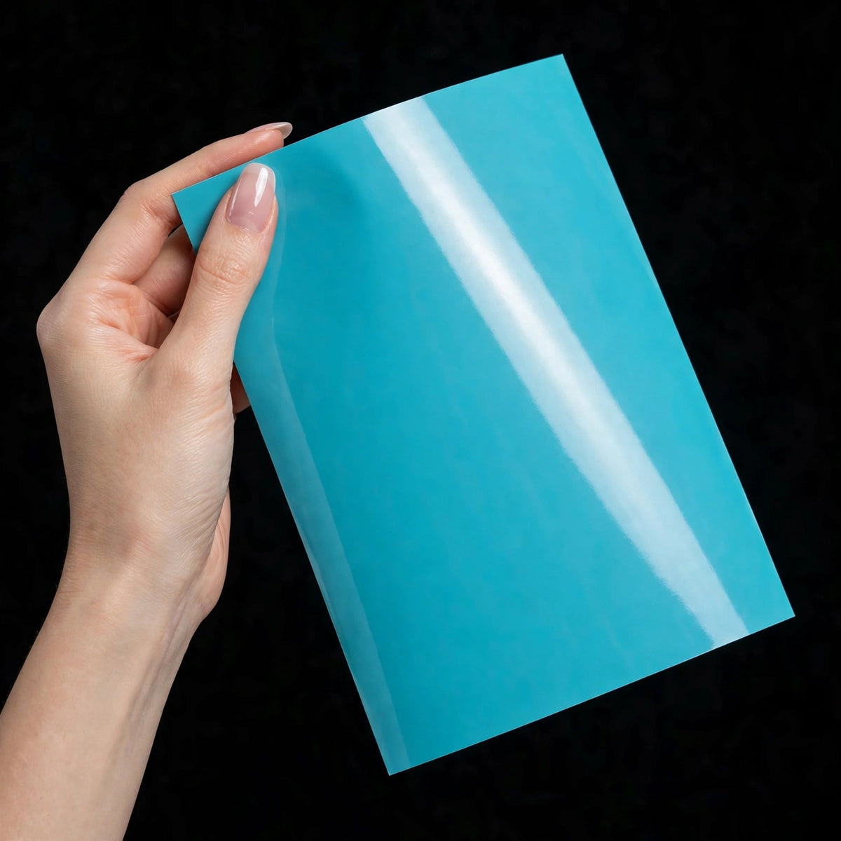 Super Gloss Coral Blue vinyl wrap film sheet held in hand