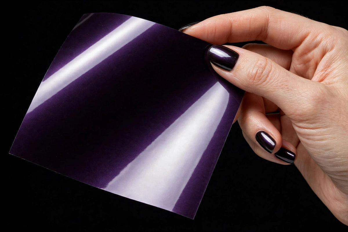 Super Gloss Pearl Black Purple vinyl wrap film sheet held in hand