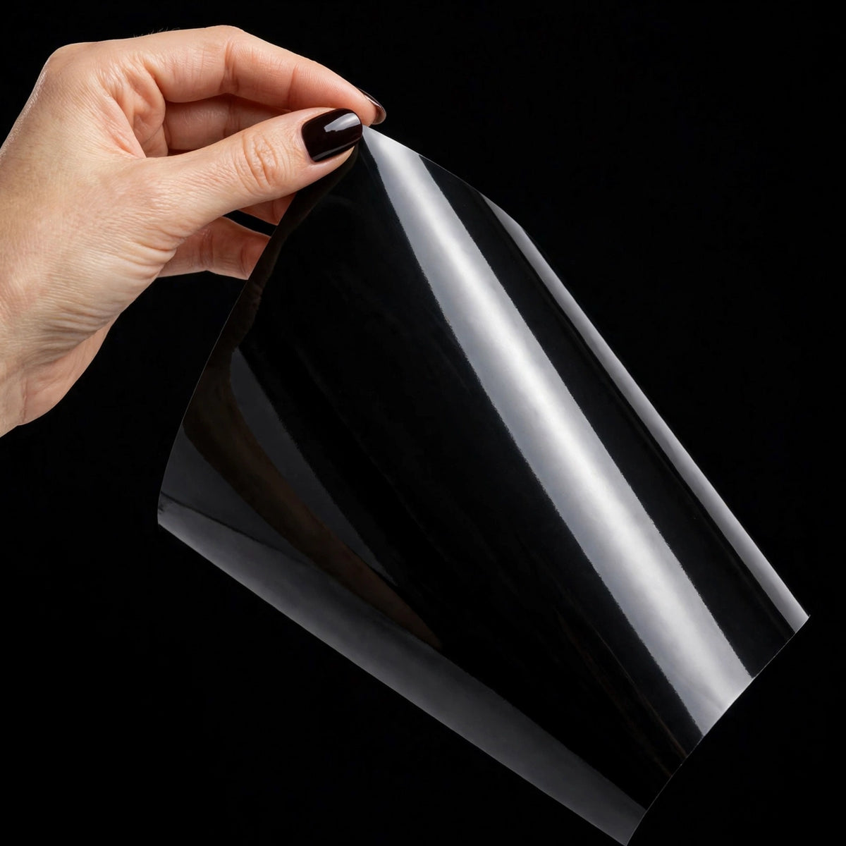 Super Gloss Pure Black vinyl wrap film sheet held in hand