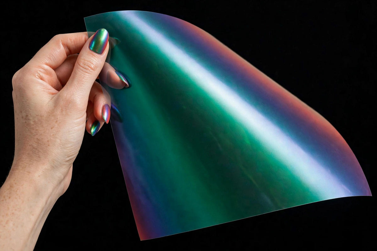Super Gloss Coral Peacock Green vinyl wrap film sheet held in hand