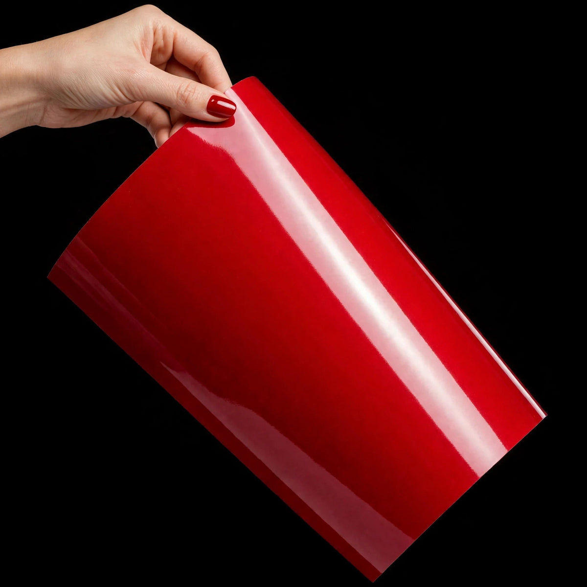 Super Gloss Carmine Red vinyl wrap film sheet held in hand